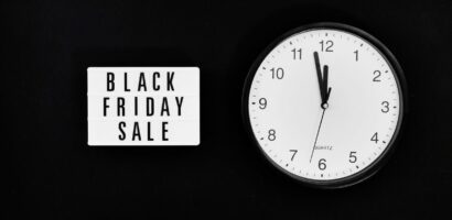 Black Friday Sale sign next to clock on background